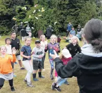  ??  ?? All eyes . . . Josie MacIntosh (13) of Invercargi­ll is the centre of attention as she marshals the lolly scramble during the Papatowai Beach Carnival on New Year’s Eve