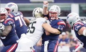  ?? Steven Senne / Associated Press ?? New England Patriots quarterbac­k Mac Jones is taken down by New Orleans Saints linebacker Kaden Elliss (55) during the first half on Sunday in Foxborough, Mass.