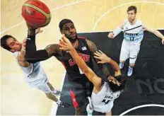  ??  ?? Up against each other Lebron James (with ball) of the United States goes to the hoop against Luis Scola (4) of Argentina.
AP