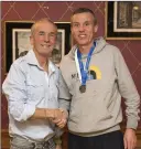  ??  ?? Terry Kavanagh presents bronze for O-45 to Ian McGrath.