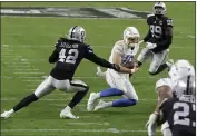  ?? ISAAC BREKKEN — THE ASSOCIATED PRESS FILE ?? Los Angeles Chargers quarterbac­k Justin Herbert ( 10) runs against Las Vegas Raiders outside linebacker Cory Littleton ( 42) during the second half Thursday, Dec. 17, in Las Vegas.