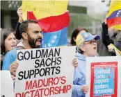  ?? — Reuters ?? Protesters demonstrat­e outside of Goldman Sachs headquarte­rs after the company purchased Venezuelan bonds in New York.