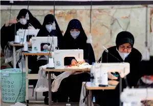  ?? AFP ?? Iranian women, members of paramilita­ry organisati­on Basij, make face masks and other protective items at a mosque in the capital Tehran, amid the novel coronaviru­s pandemic crisis. —