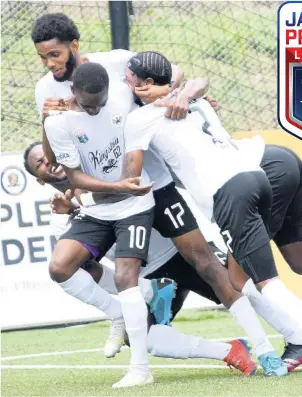 ?? IAN ALLEN ?? Members of Cavalier’s Jamaica Premier League football team celebrate after scoring their third goal in a 3-1 win over Molynes United at the UWI/Captain Horace Burrell Centre of Excellence last Saturday.