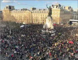  ?? MILOS KRIVOKAPIC — THE ASSOCIATED PRESS ?? Tens of thousands of people gather on the Place de la Republique after they marched peacefully to urge faster government action against global warming, Saturday in Paris.