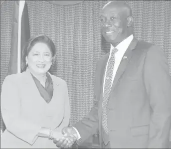  ??  ?? Prime Minister Dr Keith Rowley greets opposition leader Kamla Persad Bissessar before the start of their meeting at the Parliament Building in Port-of-Spain.