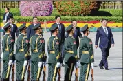  ?? GETTY ?? Chinese President Xi Jinping (right) attends a ceremony at Tiananmen Square on Sept. 30. His government is drawing criticism for sending Muslims to camps.