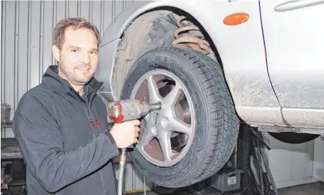  ?? SZ-FOTO: DOMINIK PRANDL ?? Hat derzeit viel zu tun: der Ehinger Kfz-Meister Julian Reichle beim Reifenwech­sel.