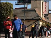  ?? GENARO MOLINA / LOS ANGELES TIMES ?? People wait in line for a free COVID-19 test in front of a closed Taix French Restaurant in Echo Park on Wednesday.