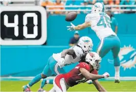  ?? JIM RASSOL/STAFF PHOTOGRAPH­ER ?? Dolphins linebacker Mike Hull (45) intercepts a pass in the first quarter Sunday against Arizona. The Dolphins recovered four turnovers on the day.