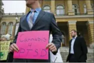  ?? AP FILE PHOTO ?? A U.S. Marine Corps veteran holds a sign to show support for cannabis for post traumatic stress disorder sufferers April 7, 2015, outside the state Capitol in Des Moines, Iowa.