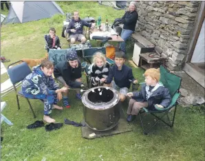  ??  ?? Cooking marshmallo­ws over an open fire ready for s’mores on an island – what an adventure.