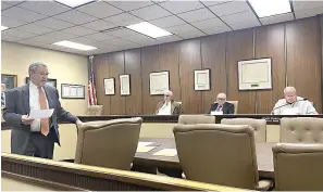  ?? Staff photo by Andrew Bell ?? ■ Texarkana Independen­t School District attorney John Mercy walks to his seat while speaking to special commission­ers, from left, Ben Franks, Dennis Lewis and John Nutt, during a March property valuation hearing in New Boston, Texas. The hearing was the latest stage in a process initiated by TISD to repurchase the district’s abandoned Pine Street Junior High campus from Old School Lofts Joint Ventures, managed by Dallas-based developer John Stone. The commission­ers were appointed by Bowie County Court at Law.