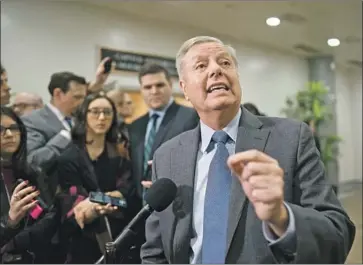  ?? J. Scott Applewhite Associated Press ?? SEN. LINDSEY GRAHAM speaks to reporters during a break in the impeachmen­t trial on Friday. The characteri­stically affable Graham has increasing­ly directed his fire at the president’s Democratic opponents.