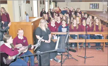  ?? ?? The Presentati­on Secondary School choir with their music teacher Ms Ryan at Thursday’s memorial Mass.