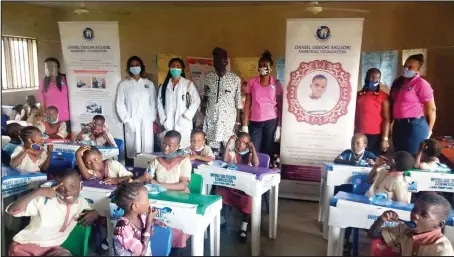  ??  ?? Officials of Daniel Ogechi Akujobi Memorial Foundation (DOAM) with the Head Teacher of Ajiran Community Primary School, Eti-Osa, Mr. Ayuba Saliu Aroundara (middle) and pupils of the school, during the deworming and vitamin supplement­s exercise, held in Lagos... recently
