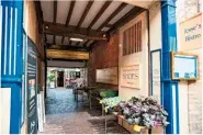  ??  ?? In the shadow of the church tower, quaint side streets lie waiting to be explored or enjoyed while taking refreshmen­ts outside at pretty pavement cafés (top). The colourful entrance to Stable Yard, where enticing independen­t shops are tucked away (above).