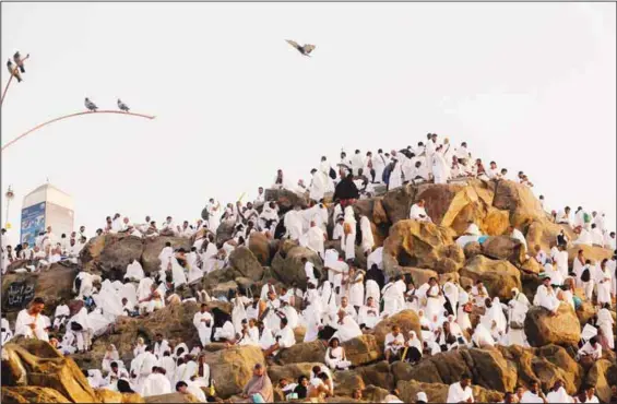  ?? (AP) ?? Muslim pilgrims pray on a rocky hill known as Mountain of Mercy, on the Plain of Arafat, during the annual Hajj pilgrimage, near the holy city of Makkah, Saudi Arabia on Aug 10. More than 2 million
pilgrims were gathered to perform initial rites of the Hajj, an Islamic pilgrimage that takes the faithful along a path traversed by the Prophet Muhammad (PBUH) some 1,400 years ago.