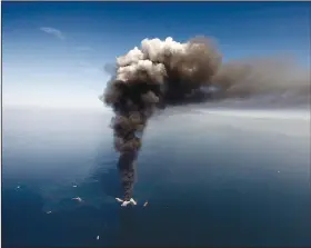  ?? (AP/Gerald Herbert) ?? This April 2010 file photo shows the Deepwater Horizon oil rig burning in the Gulf of Mexico, more than 50 miles southeast of Venice on Louisiana’s tip.