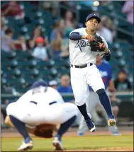  ?? File photo/NWA Democrat-Gazette/ANDY SHUPE ?? Northwest Arkansas Naturals third baseman Jack Lopez (right) makes the throw to first before leaping over starting pitcher Josh Staumont against Tulsa Drillers on Sept. 7 during the Texas League North Division Series at Arvest Ballpark in Springdale.