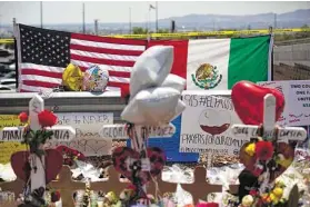  ?? Marie D. De Jesús / Staff file photo ?? A makeshift memorial honors victims of the Walmart shooting in El Paso in August, which left 22 people dead. The suspect, who is white, told police that he had targeted “Mexicans,” according to a police affidavit.