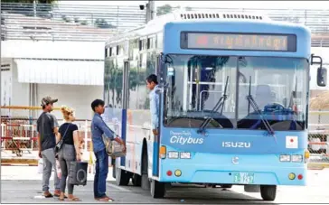  ?? HENG CHIVOAN ?? Workers take the Citybus on National Road 5 in the capital’s Russey Keo district in June.