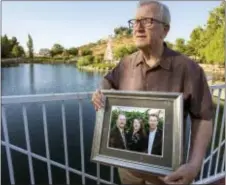  ?? ANDREW FOULK — THE ORANGE COUNTY REGISTER VIA AP ?? In this Friday photo, Frank Kerrigan holds onto a photograph of his three children John, Carole, and Frank, near Wildomar Kerrigan, who thought his son Frank had died, learned he buried the wrong man. Kerrigan said the Orange County coroner’s office...