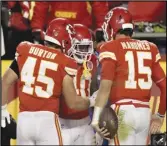  ?? Associated Press ?? Chiefs running back Derrick Gore (center) is congratula­ted by Michael Burton (45) and Patrick Mahomes (15) after scoring in the first half against the New York Giants on Monday in Kansas City, Mo.