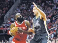  ?? Bob Levey / Getty Images ?? The Rockets’ James Harden, who scored 22 points, drives to the basket against Warriors guard Klay Thompson.