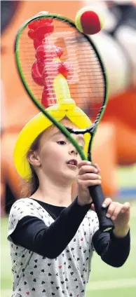  ?? PHOTO: PETER MCINTOSH ?? Game, set, match, fun . . . A determined Olivia Harwood keeps her eyes set on a pair of airborne tennis balls during the Heart Kids Family Sports Fest at the Edgar Centre on Saturday.