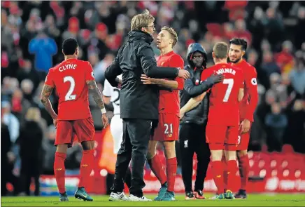  ?? Picture: GETTY IMAGES ?? LONG WAY TO GO: Liverpool manager Jurgen Klopp celebrates with Lucas Leiva after their Premier League win against Watford at Anfield on Sunday