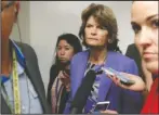  ?? The Associated Press ?? GOP: Sen. Lisa Murkowski, R-Alaska, walks on Capitol Hill on Wednesday in Washington, as reporters ask her questions.