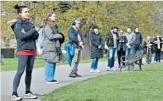  ??  ?? People queue for testing at a mobile unit in Brockwell Park in south London yesterday