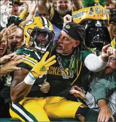  ?? MATT LUDTKE/AP ?? Packers running back Aaron Jones celebrates after one of his three TD receptions from Aaron Rodgers late in the third quarter Monday in Green Bay, Wisconsin. He added a fourth TD on a 1-yard run.