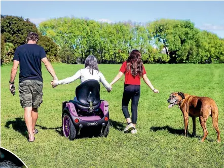  ?? BRYA INGRAM/STUFF ?? Lisa Wheeler, her daughter Sienna Wheeler, 13, husband Andrew and dog Matai can take walks together for the first time in six years.