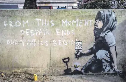  ?? Photo: Alberto Pezzali/nurphoto ?? End despair: Artist Banksy’s 2019 tribute to the Extinction Rebellion, a movement that wants states to stop global warming, which causes extreme weather and disrupts ecosystems.