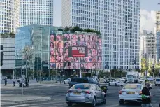  ?? Alexi J. Rosenfeld/getty Images ?? A billboard in Tel Aviv, Israel, displays photos of people kidnapped by Hamas militants, and the words ‘bring them back now.’ President Joe Biden met with Israeli leaders and families of hostages taken by Hamas during his visit to Israel Wednesday.