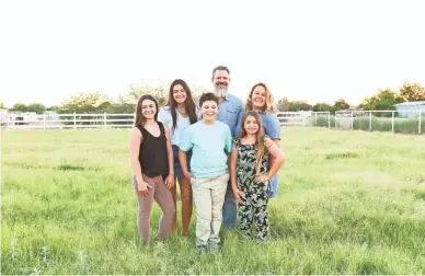  ?? COURTESY OF JENN SUTTON PHOTOGRAPH­Y ?? Ryan and Jenn Sutton in the meadow with their four children. Jenn, a photograph­er, was inspired by the home’s potential for photo opportunit­ies. Ryan runs a mortgage bank in Scottsdale with his father.