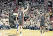  ?? MICHAEL LAUGHLIN/STAFF PHOTOGRAPH­ER ?? Miami Heat’s Kelly Olynyk celebrates hitting a three-point basket with Dion Waiters during the first half.