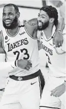  ?? ASHLEY LANDIS/POOL PHOTO VIA USA TODAY SPORTS ?? The Lakers’ LeBron James, left, and Anthony Davis won an NBA championsh­ip this month in their first season together as teammates.