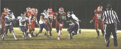  ?? The Sentinel-Record/Jami Smith ?? HOME FIELD: Mountain Pine senior running back Elijah Browning (15) splits the defense during a 63-28 homecoming win at Stanley May Field on Friday against Poyen.