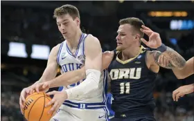  ?? PHELAN M. EBENHACK — THE ASSOCIATED PRESS ?? Duke center Kyle Filipowski, left, and Oral Roberts guard Carlos Jurgens (11) compete for a rebound during the game, Thursday, in Orlando, Fla.