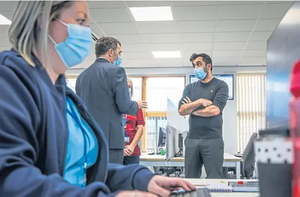  ?? ?? LAUNCH: Health Secretary Humza Yousaf speaks to NHS 24 chief executive Jim Miller at the new call centre in Dundee. Pictures by Mhairi Edwards.