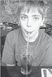  ??  ?? Matt Stockade uses a glass straw to sip his refreshing drink at the Troy Restaurant in Wolfville.