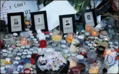  ?? (File Photo/AP/Christophe Ena) ?? Pictures of victims are placed behind candles Nov. 15, 2015, outside the Bataclan concert hall in Paris.