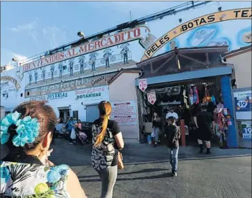  ?? Mel Melcon Los Angeles Times ?? CUSTOMERS enter El Mercado in the Boyle Heights neighborho­od of Los Angeles last April. The shopping center’s owners are demanding an environmen­tal impact report before a housing project can be built.