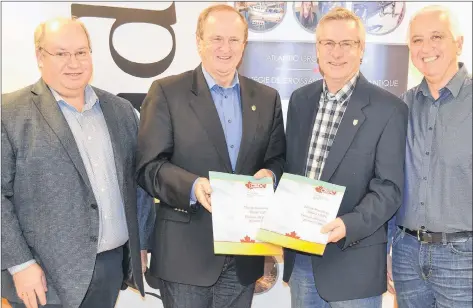  ?? ERIC MCCARTHY/JOURNAL PIONEER ?? Kevin MacLeod, left, chairman of the board of directors of CBDC West Prince Ventures, Egmont MP Bobby Morrissey, P.E.I. Fisheries Minister Robert Henderson and Rural and Regional Developmen­t Minister Pat Murphy review the applicatio­n process for the 2018-19 Quality Oyster Aquacultur­e Program.