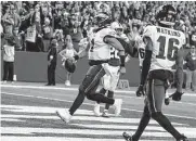  ?? Darron Cummings/associated Press ?? Eagles quarterbac­k Jalen Hurts rushes for an 8-yard touchdown in the fourth quarter Sunday against the Colts, leading Philadelph­ia to its 9th win of the year.