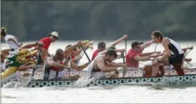  ?? JOHN BAZEMORE — THE ASSOCIATED PRESS ?? In this Thursday photo, a dragon boat crew from Germany paddles for the finish line during a 500-meter heat at the ICF Dragon Boat Championsh­ips,in Gainesvill­e, Ga.