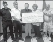  ?? Photo by Susan Holland ?? Officers of the Care and Share organizati­on in Gravette present a $45,000 check to the Gravette Fire Department at the Sept. 28 City Council meeting. The money, which was raised from proceeds at Care and Share thrift stores, will be used for life...